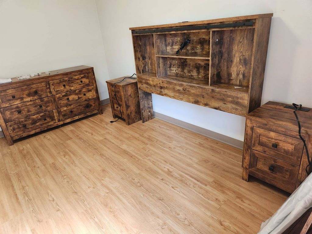 A coordinated wooden furniture set placed in a finished room.
