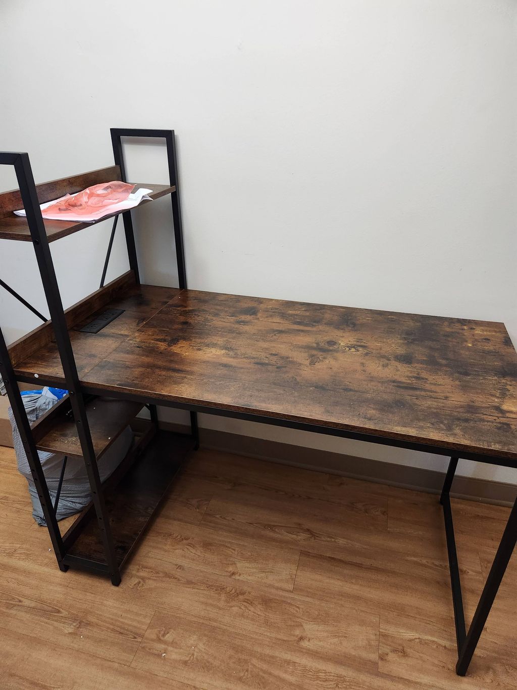 A finished wood table with a black metal frame in a room.