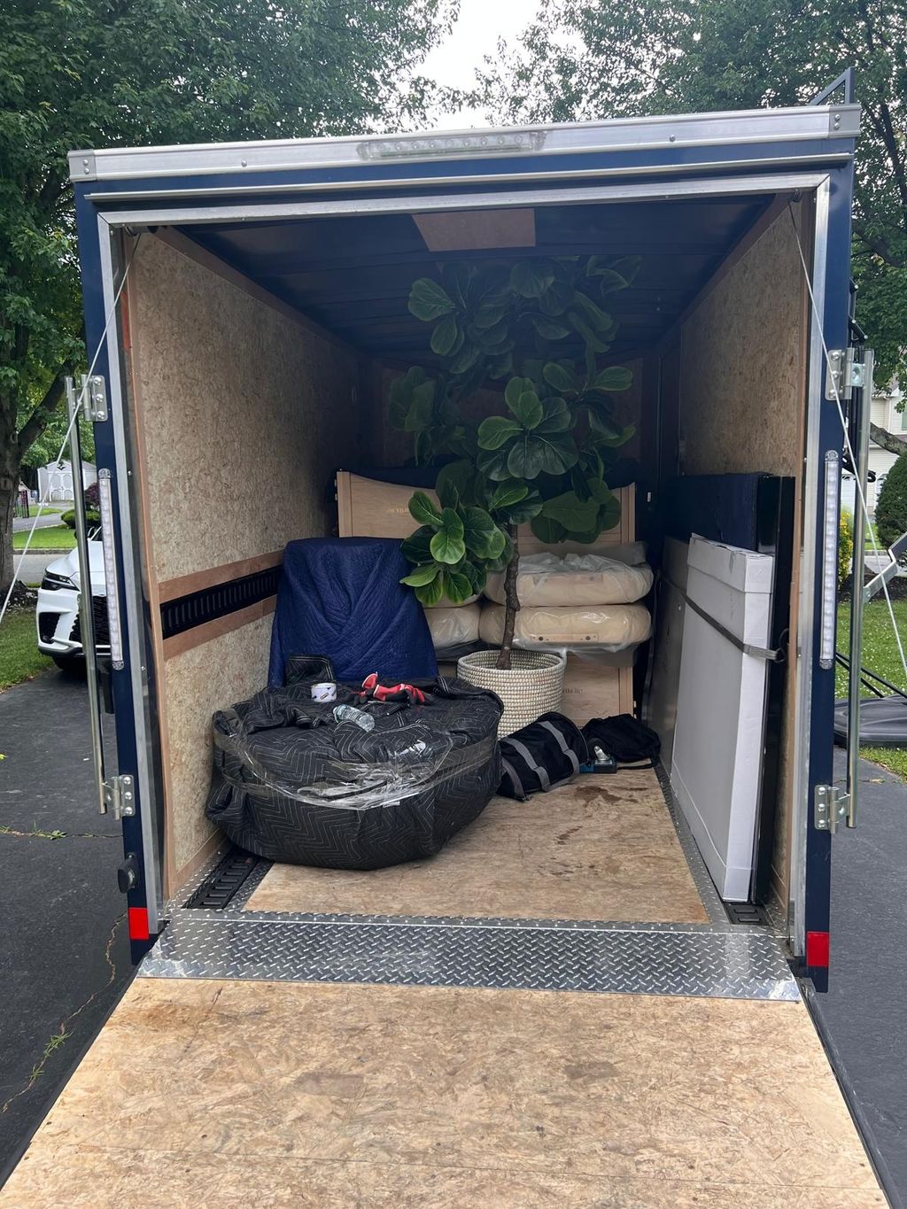 Wrapped furniture arranged inside a storage container.
